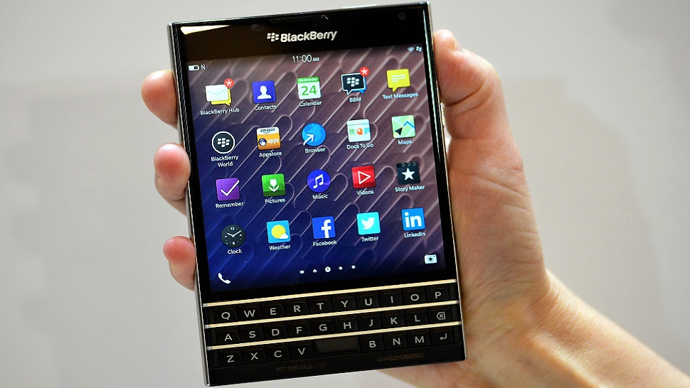 A woman holds the Blackberry Passport smartphone during at a simultaneous launch event in London on September 24, 2014. BlackBerry on Wednesday unveiled its newest smartphone with a full physical keyboard and a large screen, aiming to return to its roots targeting business users. The BlackBerry Passport, named for its approximate size to the travel document, is designed to win back key corporate users after the struggling Canadian company was effectively knocked out of the highly competitive consumer smartphone market dominated by Apple and Samsung. AFP PHOTO / CARL COURT (Photo credit should read CARL COURT/AFP/Getty Images)